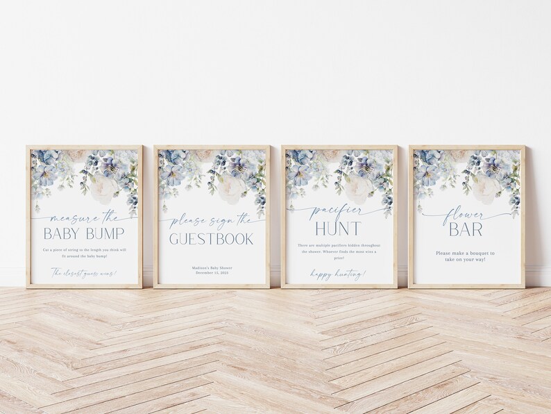 May include: Four printable signs with a watercolor floral design in shades of blue and white. The signs read "Measure the Baby Bump", "Please Sign the Guestbook", "Pacifier Hunt", and "Flower Bar".