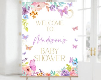 May include: Welcome to Madison's Baby Shower sign with a floral border and butterflies. The sign is white with gold lettering and purple accents.