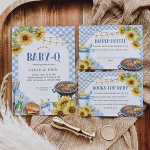 May include: Baby shower invitation set with a blue gingham pattern, sunflowers, and barbecue grill illustrations. The invitation reads "BABY-Q" and includes details for Sarah & John's baby shower. Includes diaper raffle and book request cards.