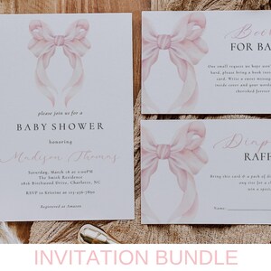 May include: A set of three printable baby shower cards with a pink watercolor bow design. The cards include a baby shower invitation, a book request card, and a diaper raffle card.