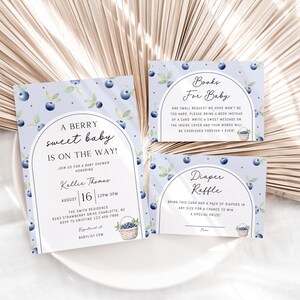 May include: A set of three baby shower cards with a blueberry theme. The invitation card says "A Berry Sweet Baby is on the Way!" with a date and time. The other two cards are for a book and diaper raffle.