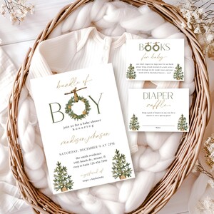 May include: A baby shower invitation set with a white onesie in a woven basket. The invitation reads "Bundle of Boy" with a wreath design. Additional cards include "Books for Baby" and "Diaper Raffle" with Christmas tree illustrations.