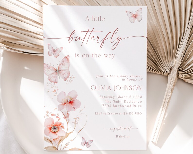 May include: A pink and white baby shower invitation with a butterfly design. The invitation reads "A little butterfly is on the way" and includes the name Olivia Johnson, the date and time of the shower, and the location. The invitation also includes the text "Registered at Babylist".