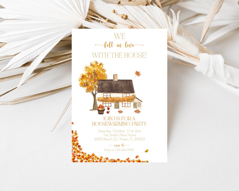 May include: A housewarming party invitation with a watercolor illustration of a house and an autumn tree. The text reads "We fell in love with the house!" and includes party details. The design features fall leaves and a warm color palette.