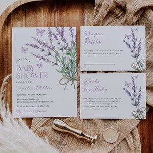 May include: Lavender-themed baby shower invitation with a watercolor illustration of lavender flowers and butterflies. The invitation includes the text "Join us for a Baby Shower honoring Amelia Miller" and details about the event, including the date, time, location, and RSVP information. The invitation also includes a diaper raffle card and a "Books for Baby" card.
