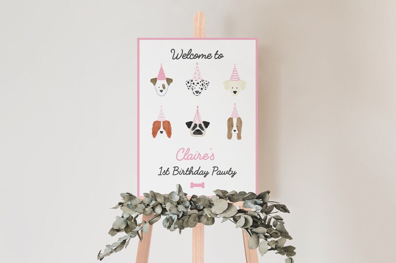 May include: A pink welcome sign with the text "Welcome to Claire's 1st Birthday Pawty" and illustrations of dogs wearing party hats.