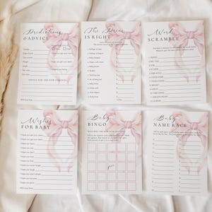 May include: A set of printable baby shower game cards featuring pink watercolor bows. The cards include games like "Predictions & Advice", "The Price is Right", "Word Scramble", "Wishes for Baby", "Baby Bingo", and "Baby Name Race".