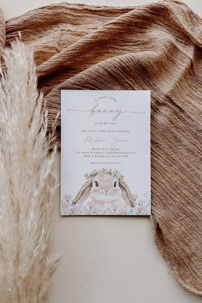 May include: A baby shower invitation with a cute illustration of a bunny wearing a flower crown. The invitation reads "a sweet little bunny is on the way!" and includes the name "Medison Jence", the date "March 18 at 2:00 pm", the location "The Smith Residence | 6293 Birchwood Drive", and the RSVP information.
