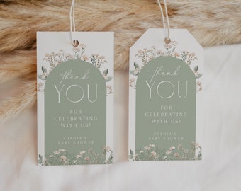 May include: Two gift tags with a floral design. The tags have a sage green arch with the words "thank YOU" in a script font. The text "FOR CELEBRATING WITH US!" and "SOPHIA'S BABY SHOWER" are also visible.