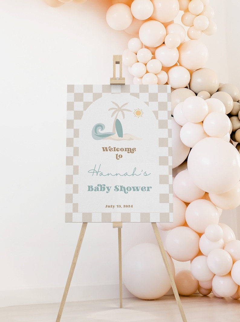 May include: A welcome sign for a baby shower with a checkered background and a beach scene with a palm tree, surfboard, and wave. The text reads "Welcome to Hannah's Baby Shower July 13, 2024".