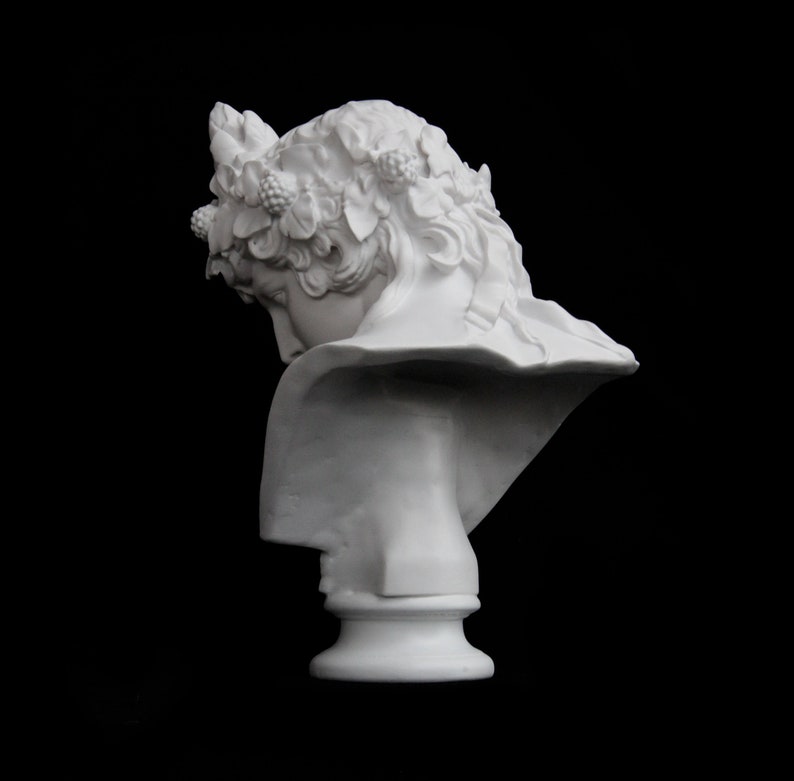 May include: White plaster bust of a woman with a crown of leaves and berries on her head. The bust is tilted to the side, and the woman's face is obscured by the crown.