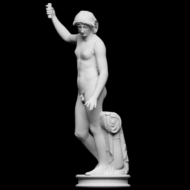 A small white 3D sculpture print of the Statue of Liberty is placed between two potted plants.