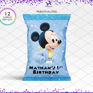 May include: A light blue party favor bag featuring a cartoon Mickey Mouse in a baby outfit. The bag has a glittery blue top and bottom, with the text "Nathan's 1st Birthday" and "12 Labels Per Qty".