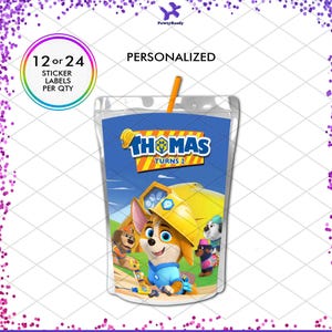 May include: A personalized juice box label featuring a cartoon dog in a construction hat. The label reads "Thomas Turns 2" and includes the text "12 or 24 sticker labels per qty". An orange straw is inserted into the juice box.