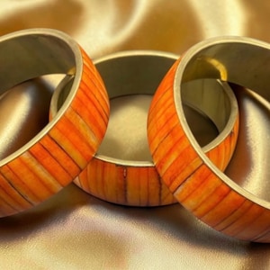 Three Vintage Brass Bangles with Segmented Orange Bone/Shell Inlay