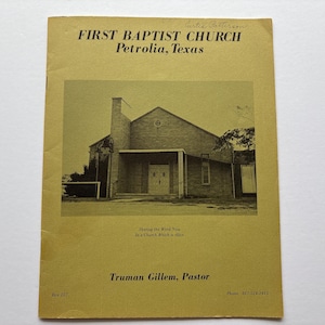May include: A yellow pamphlet with a black and white photo of a brick church building. The text reads "First Baptist Church, Petrolia, Texas" and "Truman Gillem, Pastor".