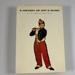 May include: A book cover titled "A History of Art & Music" featuring an illustration of a young person in a military-style uniform playing a flute. The person is wearing a black jacket, red pants, and a hat.