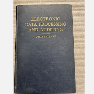 May include: A dark blue book with gold lettering on the cover. The title is "Electronic Data Processing and Auditing" by Felix Kaufman.