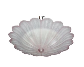 May include: A light pink, scalloped-edge ceiling light fixture. The fixture has a frosted glass appearance with a central, rounded, pink accent. The design resembles a stylized flower or shell, suitable for interior lighting.