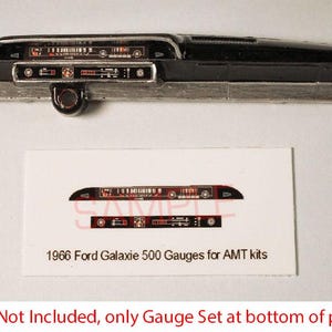 May include: A black and silver model car dashboard with gauges. The dashboard has a rectangular shape with detailed instrument panel graphics. A card below reads "1966 Ford Galaxie 500 Gauges for AMT kits".