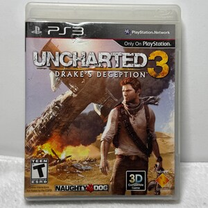 May include: A PlayStation 3 video game case for Uncharted 3: Drake's Deception. The cover art features a male character in a desert setting with a crashed airplane in the background, the Naughty Dog logo, a Teen ESRB rating, and 3D compatibility.