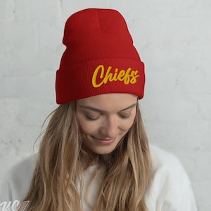 May include: Red knit beanie with a yellow embroidered "Chiefs" logo.