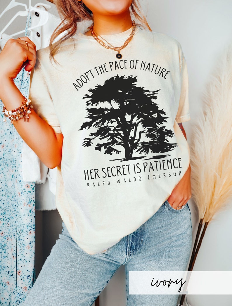 May include: A cream coloured t-shirt with a black silhouette of a tree and the text "Adopt the pace of nature. Her secret is patience. Ralph Waldo Emerson."