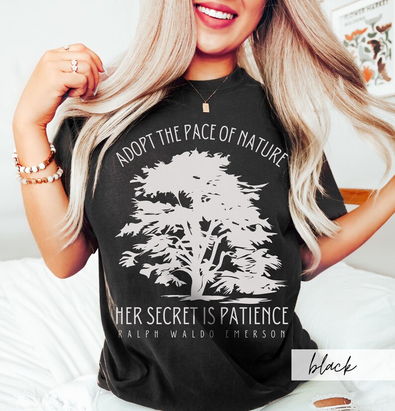 May include: Black t-shirt with a white graphic of a tree and the text "Adopt the pace of nature. Her secret is patience. Ralph Waldo Emerson."