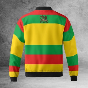 May include: A yellow, green, and red striped bomber jacket with a black collar and cuffs. The jacket features a lion emblem with the text "Selassie" on the back.