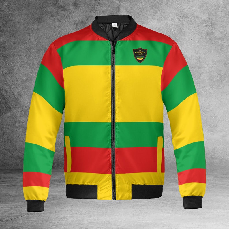 May include: A black bomber jacket with a zipper closure. The jacket has horizontal stripes in red, yellow, and green. A black patch with a gold star and the text "Black Star" is on the left side of the chest.