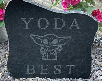 May include: A black granite stone with the words "YODA BEST" engraved on it. A cartoon image of Yoda from Star Wars is in the center of the stone.