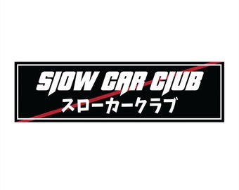 May include: Black and red rectangular sticker with white text that reads "Slow Car Club" and Japanese text that reads "スローカークラブ".