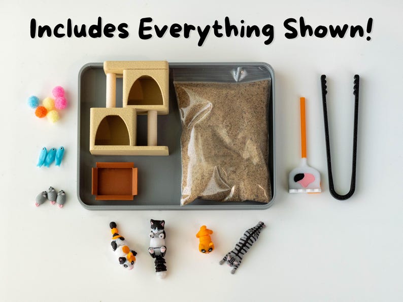 May include: A cat-themed playset includes a beige cat condo, a bag of litter, toy cats, and accessories. The set also includes a litter scoop, tongs, and colorful pom-poms. The text "Includes Everything Shown!" is at the top.