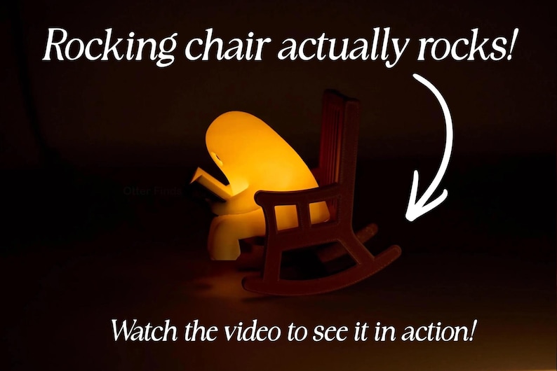 Side view of a glowing reading ghost in a brown rocking chair, with a curved arrow beside the rockers. Text reads: Rocking chair actually rocks! Watch the video to see it in action!