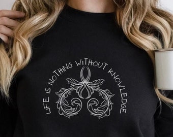 May include: Black sweatshirt with a white graphic design that says "Life is nothing without knowledge".