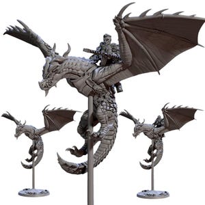 May include: A gray dragon figurine with a rider holding a weapon. The dragon has large wings and is mounted on a stand. Two smaller dragon figurines are also displayed, each on a stand.