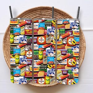 May include: Three colourful insulated tumblers with a collage of vintage food and drink labels. The labels feature images of various products, including canned goods, sweets, and beverages. The labels are in a variety of colours, including red, blue, green, and yellow.