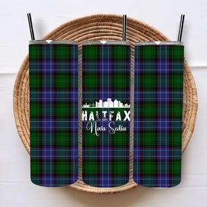 May include: Three stainless steel tumblers with a blue and green plaid pattern. The middle tumbler has a white graphic of the Halifax skyline with the text "Halifax Nova Scotia".