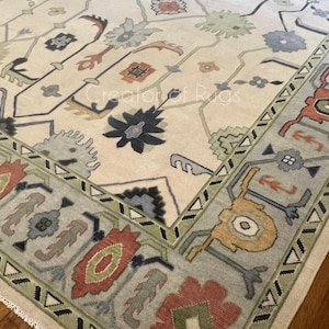 Hand Knotted Wool Oushak Rug: Beige, Green, and Coral