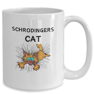 May include: White ceramic coffee mug with a black and white illustration of a cat with its fur standing on end. The text "SCHRODINGER'S CAT" is printed on the mug.