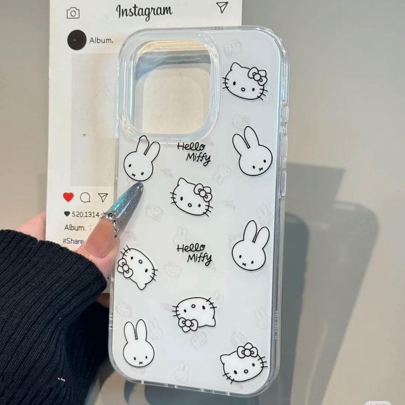 May include: Clear phone case with a repeating pattern of black and white cartoon characters, including a cat with a bow and a bunny. The words "Hello Miffy" are also printed on the case.