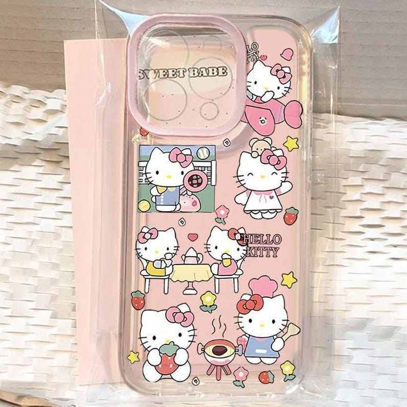 May include: A clear phone case with a pink border and a pink background featuring multiple Hello Kitty illustrations. The case has the text "SWEET BABE" at the top and "HELLO KITTY" in the center. The illustrations include Hello Kitty characters in various poses.
