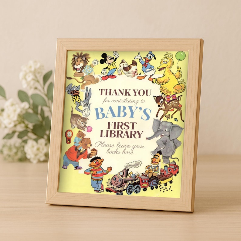 K&ouml;nnte beinhalten: Ein gerahmter Druck mit einem hellen Holzrahmen. Der Druck zeigt Cartoon-Figuren wie Mickey Mouse und Big Bird, die den Text umgeben: "DANKE f&uuml;r Ihren Beitrag zur BABY'S FIRST LIBRARY. Bitte lassen Sie Ihre B&uuml;cher hier."
