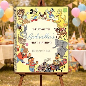 May include: A yellow sign on a wooden easel, featuring a ring of cartoon characters around the text "Welcome to Gabriella's First Birthday February 2, 2026." The sign includes illustrations of Mickey Mouse, Donald Duck, and Big Bird.