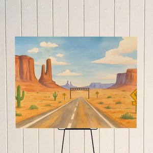 May include: A watercolour painting depicting a desert scene with a road stretching to the horizon. The artwork shows red rock formations, cacti, and yellow road signs under a blue sky with clouds. The painting is displayed on a black easel.