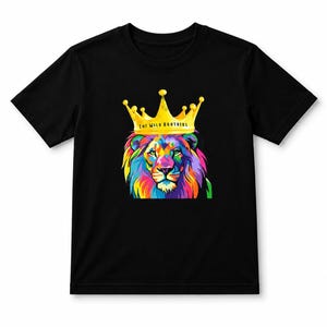 May include: Black t-shirt with a colourful lion design wearing a gold crown. The lion's mane and face are a vibrant mix of rainbow colours. The text "THE WILD BROTHERS" is printed on the crown.