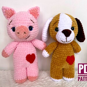 May include: Two crocheted stuffed animals, a pink pig and a brown and white dog, both with red hearts on their chests.  The animals are standing on a white surface.  PDF PATTERN.