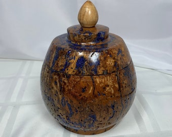 Wood urn with lid turned from reclaimed red oak burl with deep blue glitter-filled insect holes