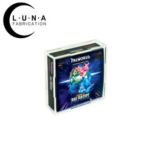 May include: A clear acrylic display case containing a Palworld Dawn of Palpagos official card game booster box. The box features blue and purple graphics with various creature illustrations and the text Palworld and Dawn of Palpagos.