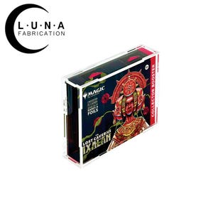 May include: A clear acrylic display case for a Magic: The Gathering Collector Booster box. The box features a vibrant illustration of a figure with a headdress, and the text "The Lost Caverns of Ixalan". The case is designed to protect and showcase the collectible.